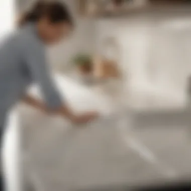 User applying cleaner on quartz countertop with a cloth